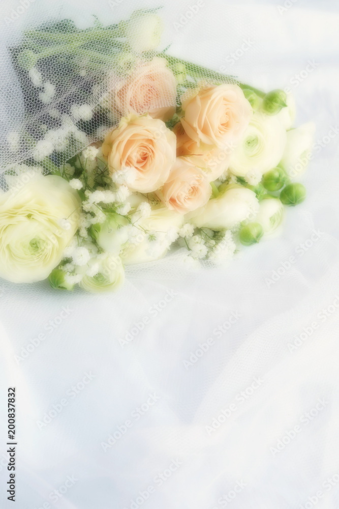 Blure effect, soft focus. Beautiful bridal bouquet from pale pink roses and white ranunculus flowers on white linen fabric background. copy space Blure effect, soft focus. Beautiful bridal bouquet from pale pink roses and white ranunculus flowers on white linen fabric background. copy space