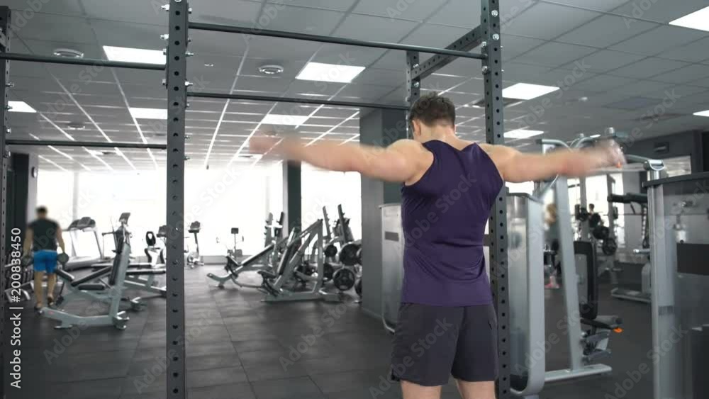 Athlete male warming up before gym workout, fitness lifestyle, bodybuilding Athlete male warming up before gym workout, fitness lifestyle, bodybuilding