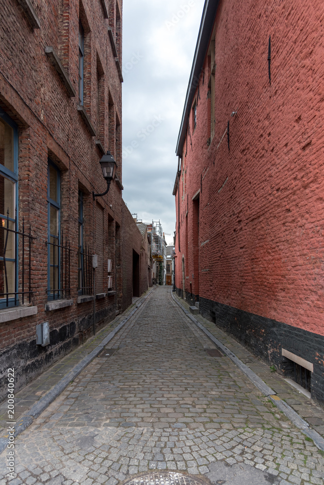 Narrow alley between brick walls in Ghent Belgium