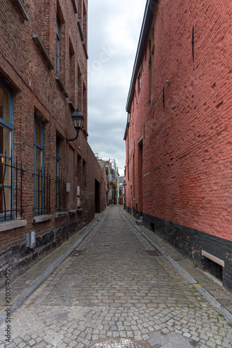 Narrow alley between brick walls in Ghent Belgium