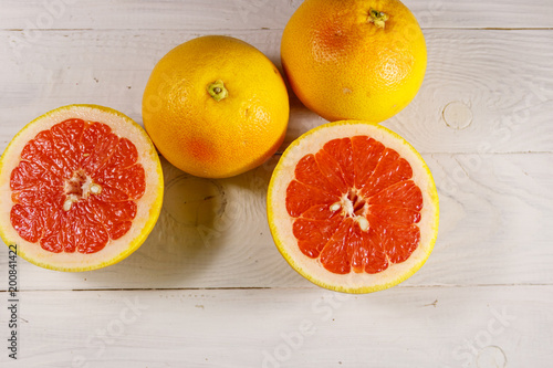 Ripe fresh grapefruits on white wooden table