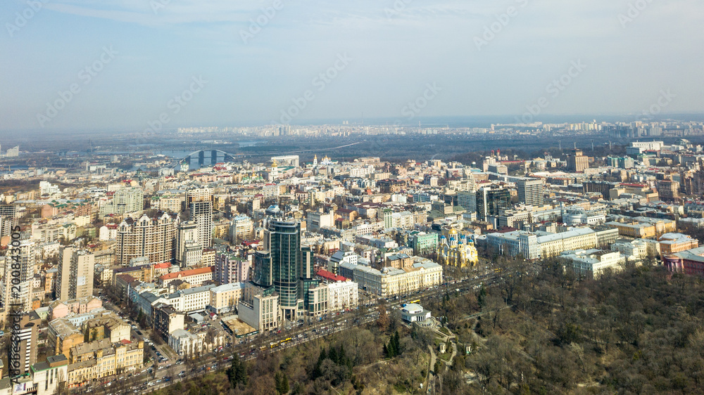 City of Kiev on a sunny day. Modern high-rise buildings and a park. Aerial photo from the drone