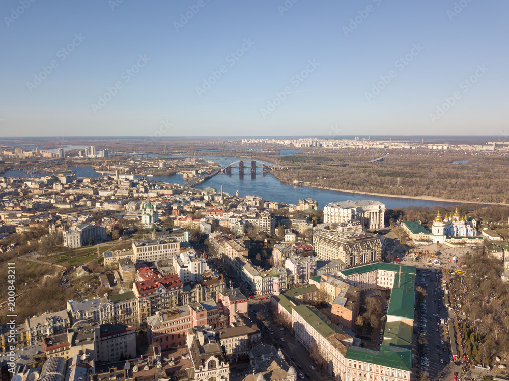 Kiev, Ukraine - April 7, 2018: Landscape view of the old district of Podol with the Vladimir Church and St. Andrew's Church against the blue sky
