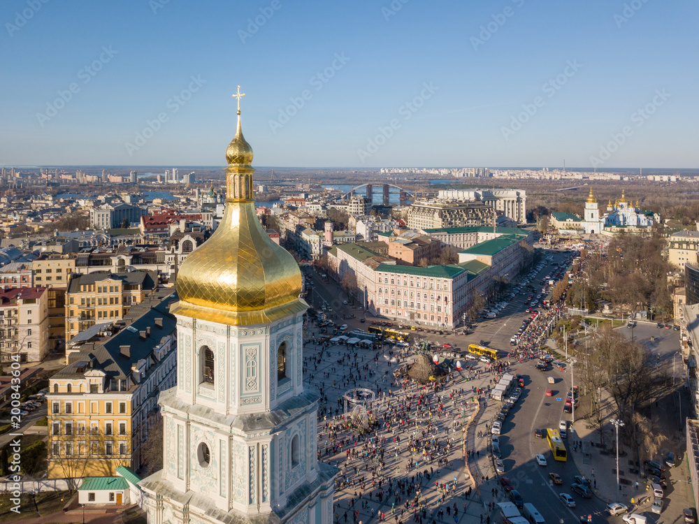 view landscape in Kiev with St. Sophia bell tower and people sightseeing at Sofiiska square