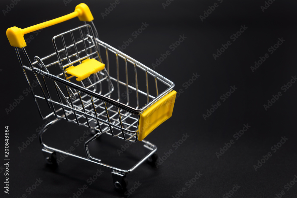Yellow mini cart or trolley on black