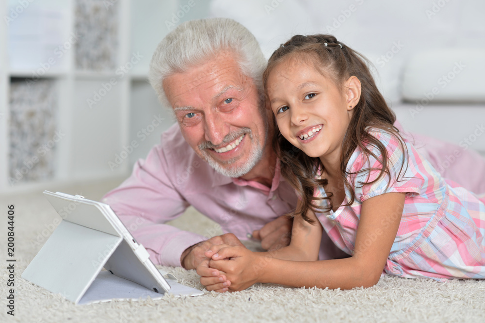 portrait of girl and grandfather with a tablet portrait of girl and grandfather with a tablet