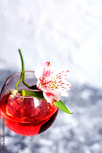 Red cocktail with flowers. Nikerboker.Rom with cranberries