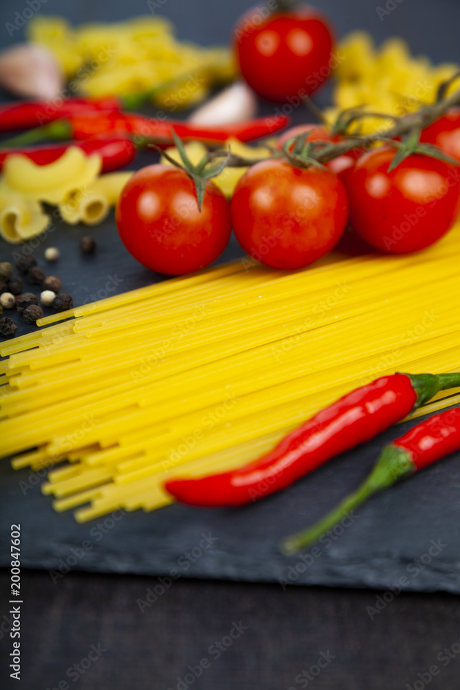 Different pasta on a dark wooden background Different pasta on a dark wooden background