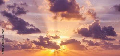 Bright colorful sunset sky, clouds and sun rays, natural background and texture
