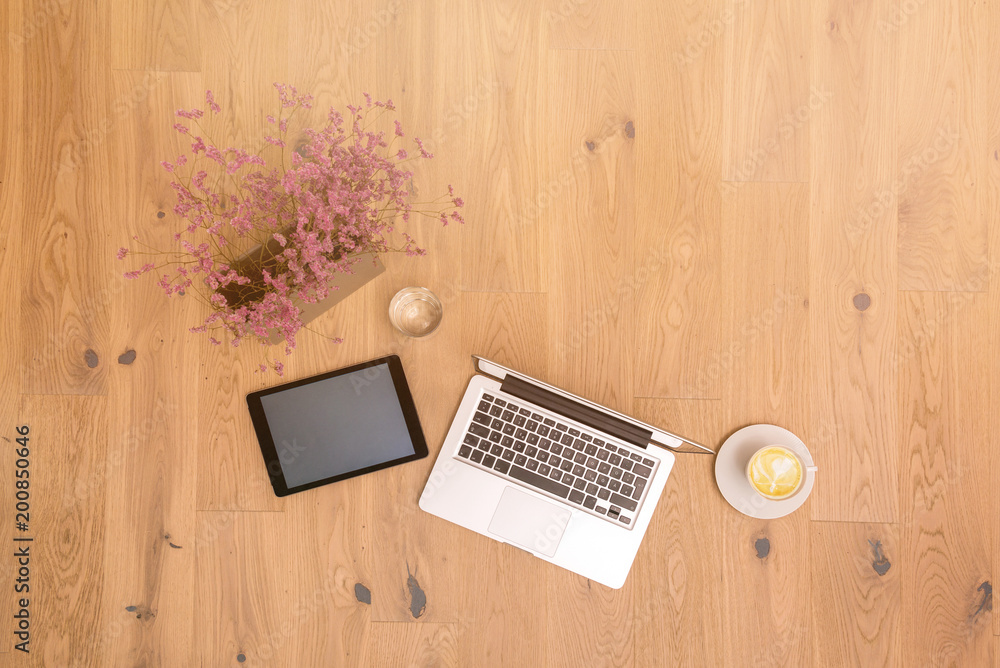 Laptop and tablet with copy space on wooden floor as flat lay Laptop and tablet with copy space on wooden floor as flat lay