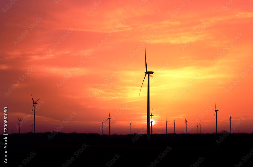 Obraz premium Windmill generators farm at sunset..