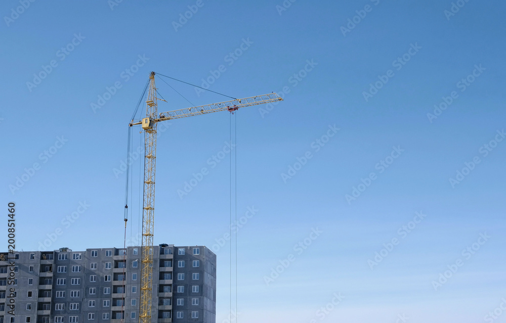 Construction of a multi-storey building. Crane on sky background. Construction of a multi-storey building. Crane on sky background.