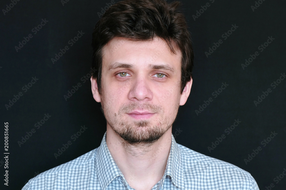 Obraz premium Portrait of young handsome man in plaid short looking at camera.