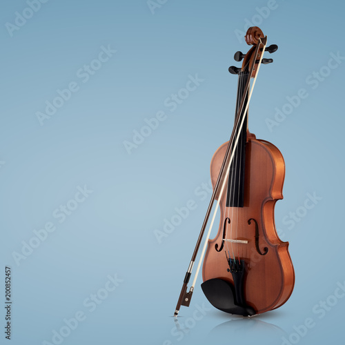 Violin musical instruments of orchestra closeup on blue