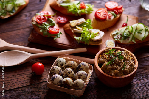 Breakfast still life with sandwiches, quail eggs, spicies and fresh fruits and vegetables, selective focus