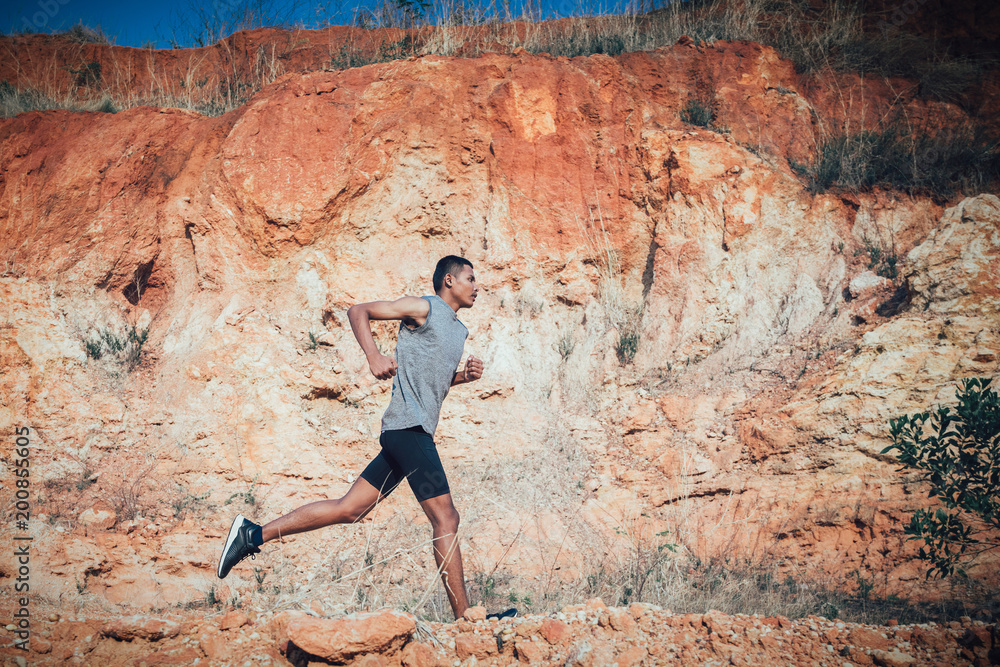 Naklejka premium fit man running outdoor cross-country concept of exercising