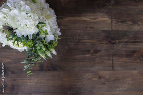 White flowers on a brown wooden floor. View from above © vfhnb12