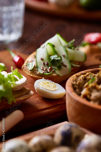 Breakfast sandwich with homemade paste, vegetables and fresh greens, shallow depth of field