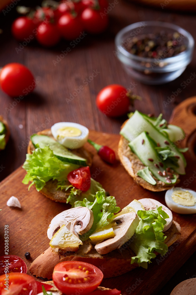 Breakfast sandwich with homemade paste, vegetables and fresh greens, shallow depth of field Breakfast sandwich with homemade paste, vegetables and fresh greens, shallow depth of field