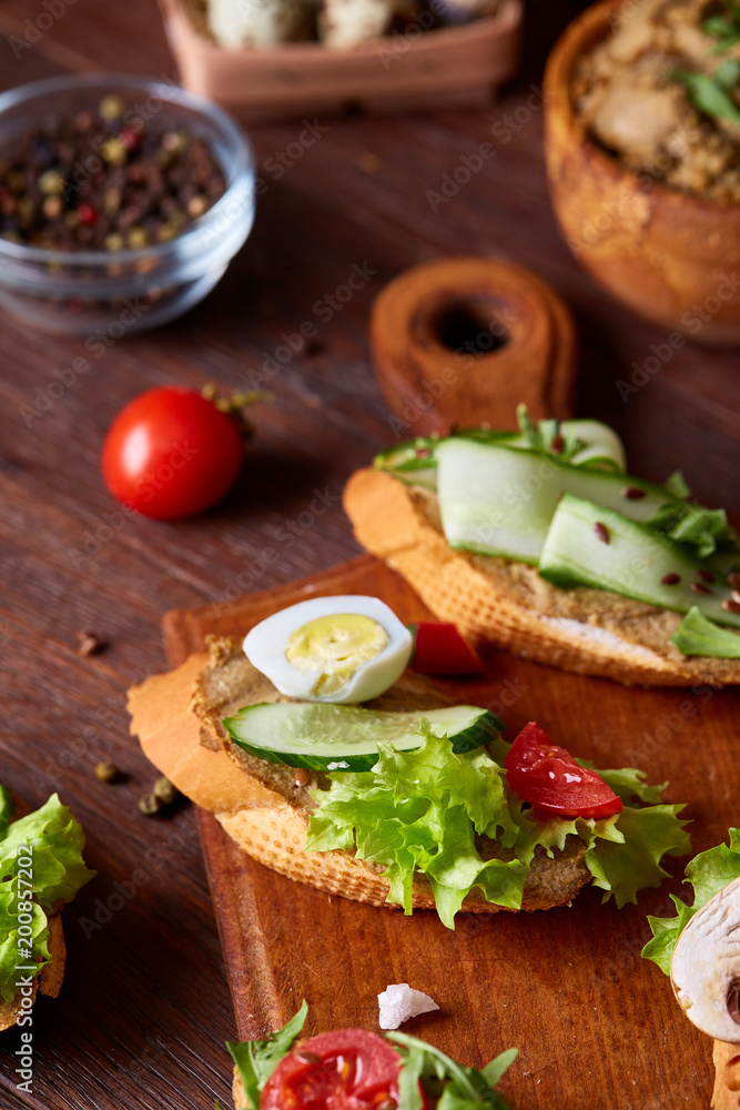 Breakfast still life with sandwiches, quail eggs, spicies and fresh fruits and vegetables, selective focus Breakfast still life with sandwiches, quail eggs, spicies and fresh fruits and vegetables, selective focus