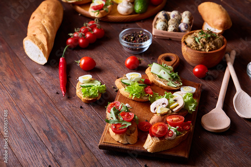 Breakfast still life with sandwiches, quail eggs, spicies and fresh fruits and vegetables, selective focus photo