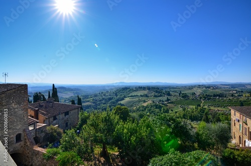 San Gimignano  Italy  Tuscany region. August 14 2016. Landscape seen from the top of San Gimignano towards the valley. Green hills alternate with vineyards and fields cultivated in the countryside.
