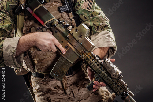 Soldier wearing uniform with gun in hand,keep gun in the holster. military concept