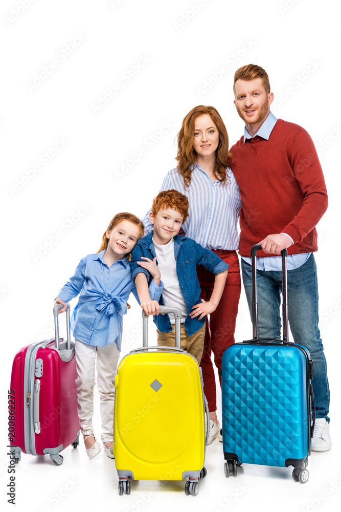 red haired family with suitcases standing together and smiling at camera isolated on white red haired family with suitcases standing together and smiling at camera isolated on white