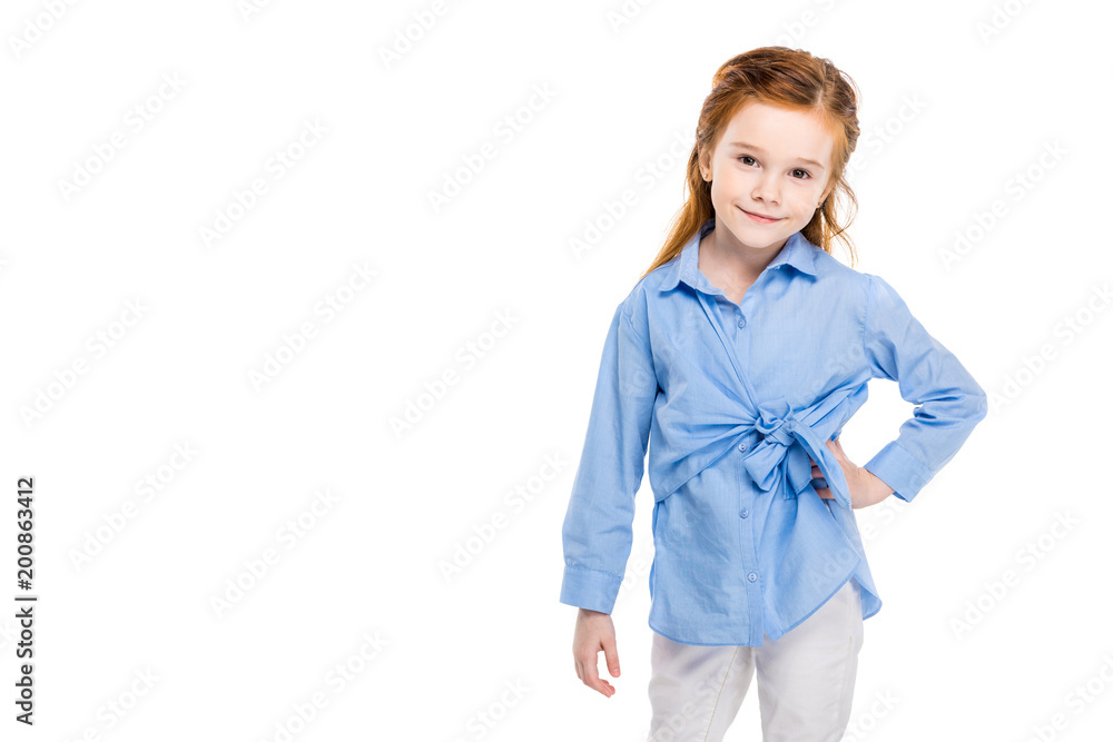 beautiful little child standing with hand on waist and smiling at camera isolated on white beautiful little child standing with hand on waist and smiling at camera isolated on white