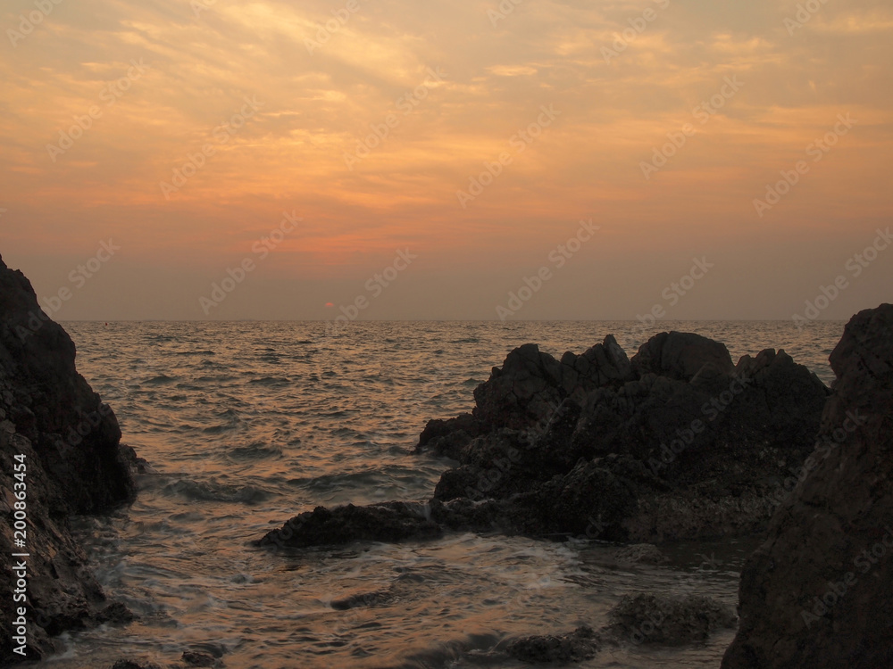 Sunset view over sea with stones
