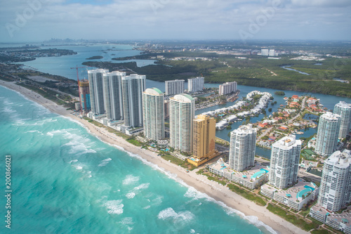 North Miami Beach buildings as seen from helicopter  Florida. Skyscrapers along the ocean  aerial view.