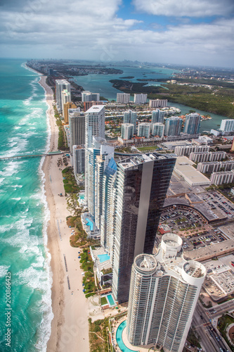 North Miami Beach as seen from helicopter. Skyscrapers along the ocean, aerial view