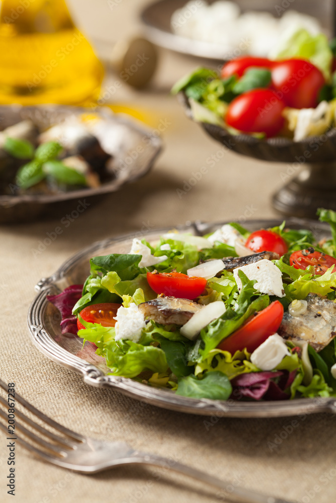A delicious salad with sardines and feta cheese. A delicious salad with sardines and feta cheese.