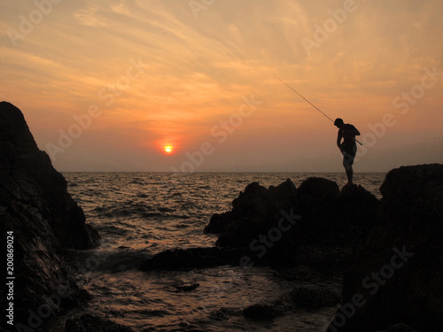 fishermen silhouette at sunset