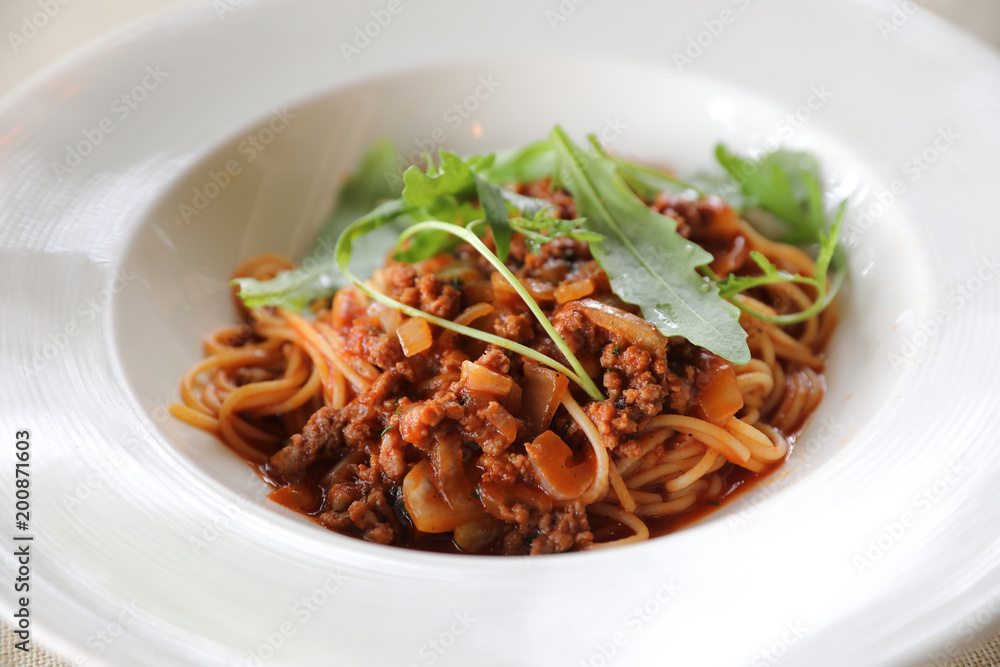 spaghetti Bolognese with minced beef and tomato sauce garnished with parmesan cheese and basil , Italian food spaghetti Bolognese with minced beef and tomato sauce garnished with parmesan cheese and basil , Italian food