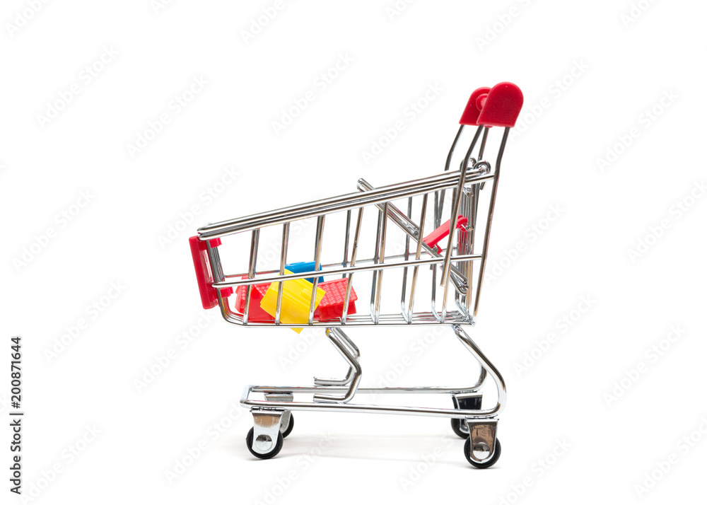 Miniature house and shopping cart on white background : economy concept Miniature house and shopping cart on white background : economy concept