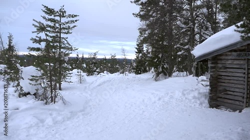 Riisitunturi kansallispuisto, Slow motion pan view from the cabin to the sign, at the port of the national park, on a earley morning, at a fjeld mountain fell, in Lapland, Finland photo