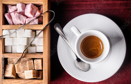 Espresso with colored sugar on a dark tablecloth photo