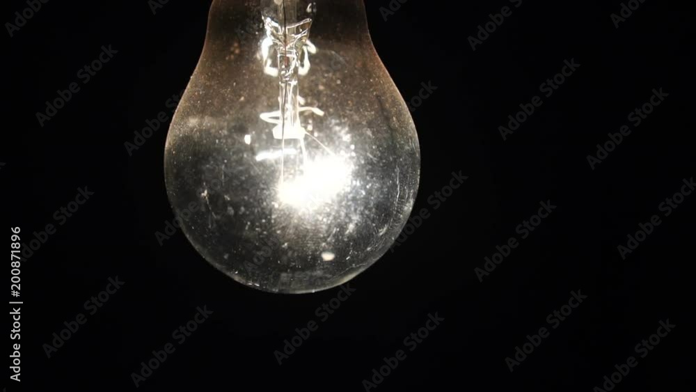 included light bulb slowly swings on the wire. the incandescent lamp is shining in the dark. Slow motion included light bulb slowly swings on the wire. the incandescent lamp is shining in the dark. Slow motion