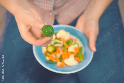 Girl with a plate of vegetables in hands. Healthy eating concept. Proper nutrition. Vegetarian food. Vegans food. Toned image.