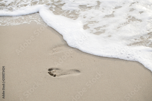 Foto Footprints walking on the beach by the morning