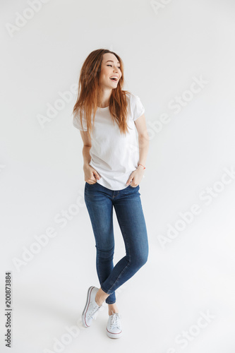 Full length image of Cheerful woman in t-shirt posing