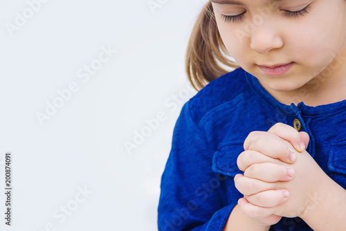 The child prays. Selective focus. 