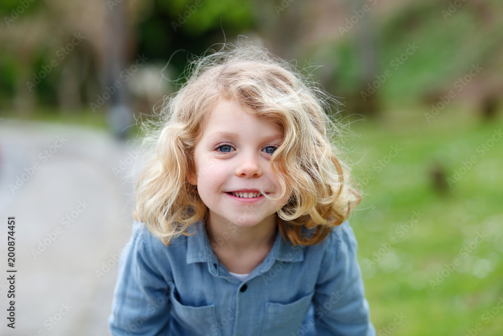 Happy child with long blond hair enjoying the nature Happy child with long blond hair enjoying the nature