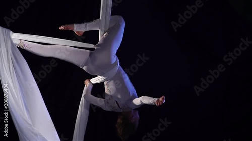 woman dancer on aerial silk, aerial contortion, aerial ribbons. Slow Motion