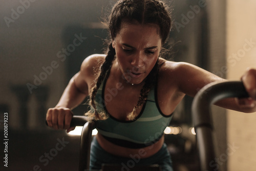 Woman doing intense workout on gym bike photo