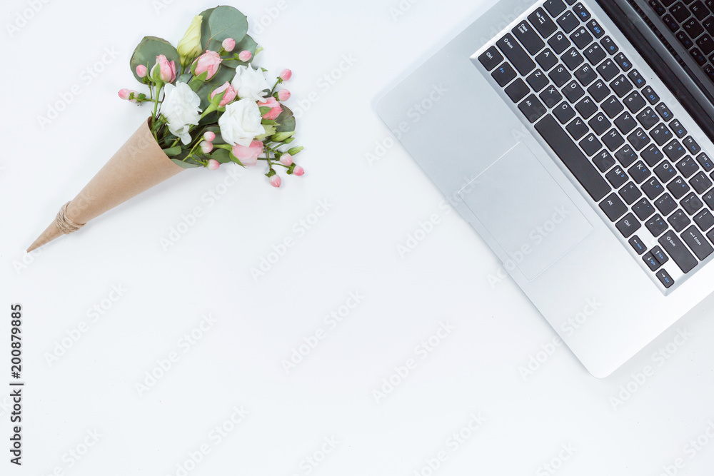 Top view of white office desk table with laptop, notebook, flower composition. Copy space, flat lay. Top view of white office desk table with laptop, notebook, flower composition. Copy space, flat lay.