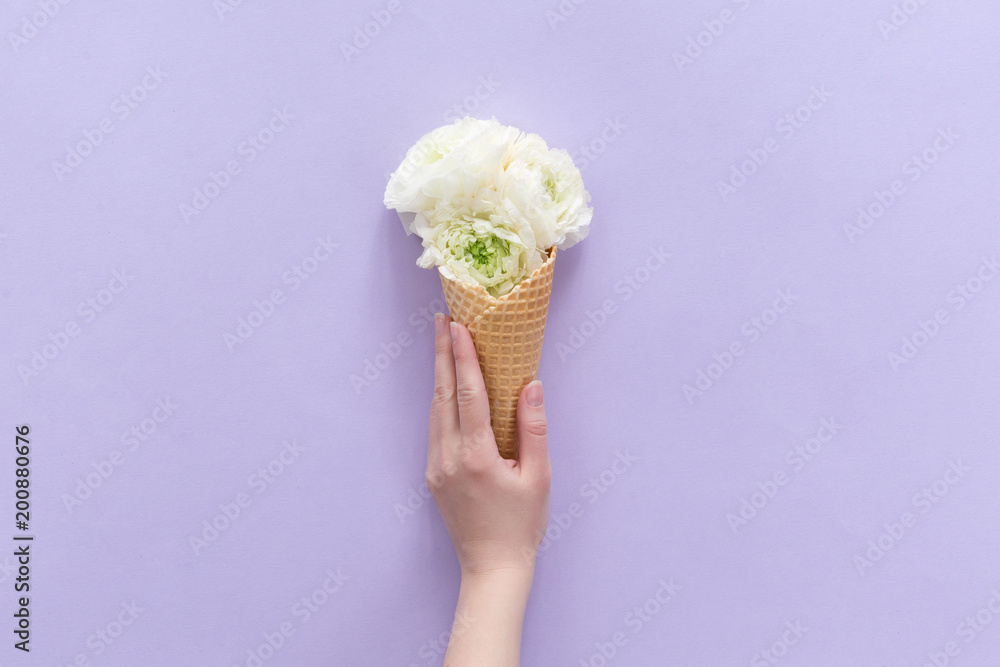 Top view of waffle cone with flowers bouquet on lilac or violet background, flat lay Top view of waffle cone with flowers bouquet on lilac or violet background, flat lay