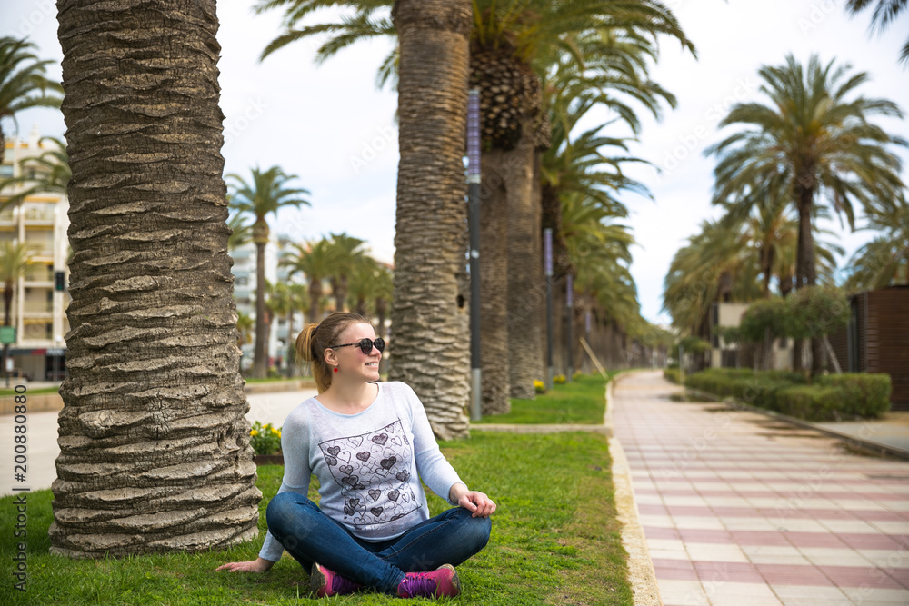Pretty woman relax on coastline Costa Dorada, Salou, Spain. Beautiful sea and palms