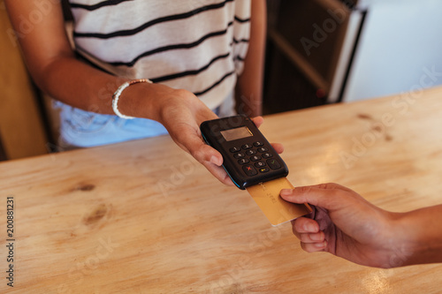 Woman making a wireless card transaction payment